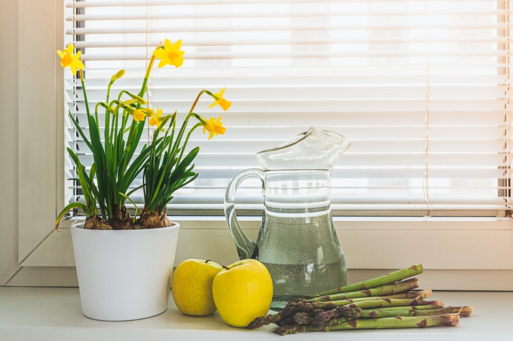 Spring decor in home interior of fresh vegetables, fruits, fresh flowers